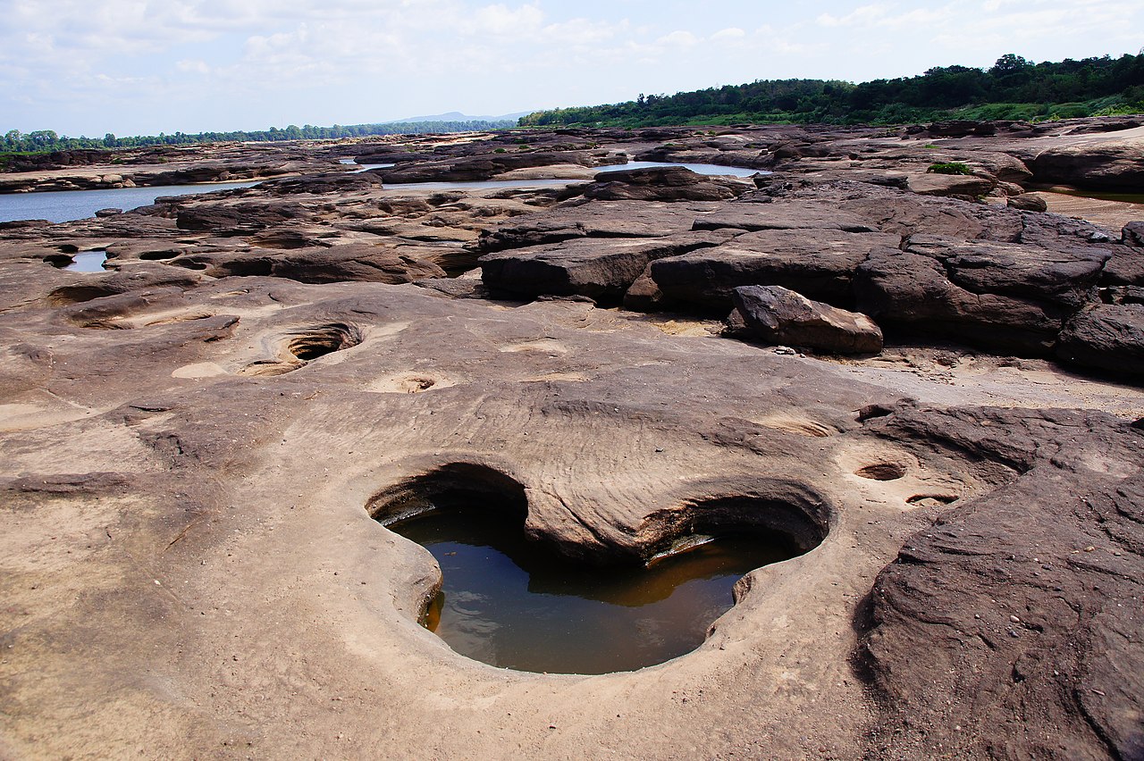 A view from a mountain top across a lush jungle scene.